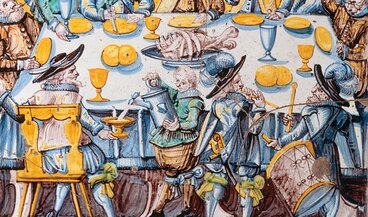 Carreau de poêle représentant un repas dans une salle de corporation ou de conseil du canton de Zurich, vers 1650
